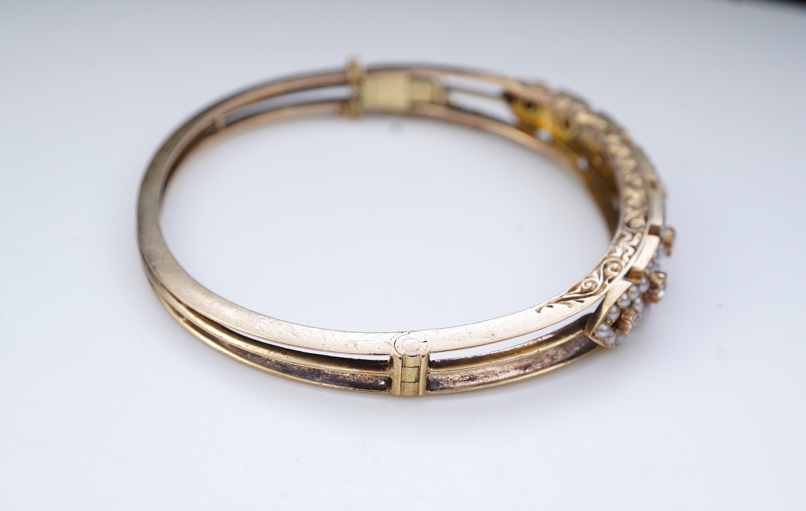 An Edwardian seed pearl and diamond bangle, early 20th century